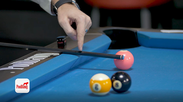 Florian uses his cue to measure the distance between the channel and his point of impact on the object ball.