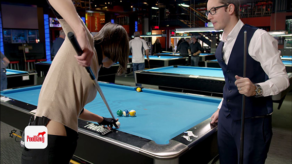 Valerie takes aim just above the center of the cue ball and jumps into the one ball